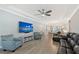 Open concept living room with wood floors, large television and comfortable seating area at 5187 Barnett Cir, Bradenton, FL 34211