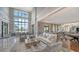 Elegant lobby with high ceilings, comfortable seating, and expansive windows offering a view of the inviting pool area at 5187 Barnett Cir, Lakewood Ranch, FL 34211