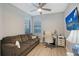 Office with a comfortable couch, ceiling fan, desk with chair, and mounted TV at 5187 Barnett Cir, Lakewood Ranch, FL 34211