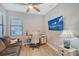 Comfortable office with hardwood flooring, desk space, sofa, ceiling fan and wall-mounted television at 5187 Barnett Cir, Lakewood Ranch, FL 34211