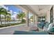 Covered patio overlooking community pool with outdoor seating and beautiful palm trees at 5187 Barnett Cir, Lakewood Ranch, FL 34211