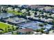 Aerial view of multiple tennis courts and neighborhood, perfect for residents enjoying active outdoor recreation at 5187 Barnett Cir, Lakewood Ranch, FL 34211