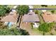 Birds-eye view of home with a fenced yard, patio, and mature landscaping surrounding it at 5192 Cedar Hammock Ln, Sarasota, FL 34232