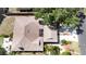 Aerial view of home with mature landscaping, driveway, and screened-in porch at 5192 Cedar Hammock Ln, Sarasota, FL 34232