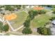 Community aerial view showing baseball fields, tennis courts, and green spaces at 5192 Cedar Hammock Ln, Sarasota, FL 34232