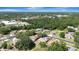Aerial view of the neighborhood, featuring lush greenery, trees, and nearby buildings at 5192 Cedar Hammock Ln, Sarasota, FL 34232
