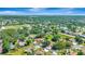 Lush, green aerial view shows landscaping, a pond, and surrounding neighborhood at 5192 Cedar Hammock Ln, Sarasota, FL 34232