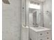 Modern bathroom features marble tile shower with glass enclosure and vanity with marble countertop at 5192 Cedar Hammock Ln, Sarasota, FL 34232
