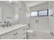 Bright bathroom featuring white tile, a shower-tub combo, and modern fixtures at 5192 Cedar Hammock Ln, Sarasota, FL 34232
