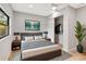Comfortable bedroom features a closet with hanging storage, a large window and neutral decor at 5192 Cedar Hammock Ln, Sarasota, FL 34232