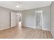Spacious bedroom showcasing wood floors, neutral walls, and access to an updated bathroom at 5192 Cedar Hammock Ln, Sarasota, FL 34232