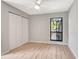 Comfortable bedroom featuring a ceiling fan, closet, and a window to the outside at 5192 Cedar Hammock Ln, Sarasota, FL 34232