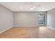 Spacious bedroom with wood floors, a ceiling fan, and a large window at 5192 Cedar Hammock Ln, Sarasota, FL 34232