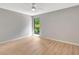 Bright bedroom with a window offering natural light and views of lush greenery at 5192 Cedar Hammock Ln, Sarasota, FL 34232