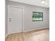 Bright, airy room with wood flooring featuring entrance door and window providing natural light at 5192 Cedar Hammock Ln, Sarasota, FL 34232