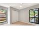 Bright bedroom with wood floors, large windows, and a double closet at 5192 Cedar Hammock Ln, Sarasota, FL 34232
