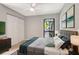 Bright bedroom with a large window, a closet and soothing, neutral decor at 5192 Cedar Hammock Ln, Sarasota, FL 34232