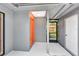 The entryway boasts neutral paint colors and the orange front door offers a pop of color at 5192 Cedar Hammock Ln, Sarasota, FL 34232
