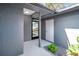 A bright entryway featuring neutral colors, leading to a screened-in porch, and the front door at 5192 Cedar Hammock Ln, Sarasota, FL 34232