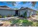 Charming front entrance with a screened doorway, tidy landscaping, and a welcoming walkway at 5192 Cedar Hammock Ln, Sarasota, FL 34232