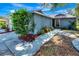 A well-manicured front yard and walkway lead to the entrance of this charming single-story home at 5192 Cedar Hammock Ln, Sarasota, FL 34232