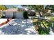 Charming single-story home with a well-maintained front yard, two-car garage, and mature shade trees at 5192 Cedar Hammock Ln, Sarasota, FL 34232