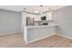 Kitchen featuring white cabinets, stainless steel appliances, backsplash, and breakfast bar with pendant lights at 5192 Cedar Hammock Ln, Sarasota, FL 34232