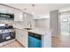Bright kitchen features stainless steel appliances, breakfast bar, and a blue dishwasher and microwave at 5192 Cedar Hammock Ln, Sarasota, FL 34232