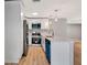 Bright kitchen features stainless steel appliances, breakfast bar, and a blue dishwasher and microwave at 5192 Cedar Hammock Ln, Sarasota, FL 34232