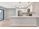 An open kitchen features modern stainless steel appliances, an island with bar seating, and pendant lights at 5192 Cedar Hammock Ln, Sarasota, FL 34232