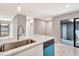Bright kitchen features stainless steel sink, dishwasher, and sliding door to a courtyard at 5192 Cedar Hammock Ln, Sarasota, FL 34232