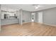 Open-concept living area with hardwood floors, modern kitchen with breakfast bar, and neutral wall colors at 5192 Cedar Hammock Ln, Sarasota, FL 34232