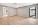 Well lit room with wood floors, neutral walls, a ceiling fan, and a view to the outside at 5192 Cedar Hammock Ln, Sarasota, FL 34232