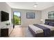 Serene main bedroom offering a large window, mounted TV, and contemporary furnishings at 5192 Cedar Hammock Ln, Sarasota, FL 34232