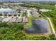 Aerial view of a house in a community with access to a serene backyard pond, providing a peaceful, natural backdrop at 5240 Bentgrass Way, Bradenton, FL 34211