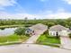 Stunning aerial view of a house with pond, well-manicured lawn and a brick paved driveway at 5240 Bentgrass Way, Bradenton, FL 34211