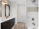 Bathroom with double vanity, modern fixtures, and a tiled shower at 5240 Bentgrass Way, Bradenton, FL 34211