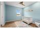 Bedroom with wood floors, ceiling fan, and a large window with natural light at 5240 Bentgrass Way, Bradenton, FL 34211