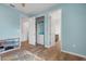 A blue painted bedroom featuring an en suite bathroom and a closet at 5240 Bentgrass Way, Bradenton, FL 34211