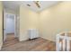 A simple Bedroom room with wood-like ceramic flooring, crib and a dresser at 5240 Bentgrass Way, Bradenton, FL 34211
