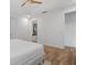 Well-lit bedroom featuring tray ceiling, wood-look floors, and a bathroom entrance at 5240 Bentgrass Way, Bradenton, FL 34211