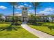 Inviting community clubhouse with manicured lawn, swaying palm trees and sidewalk at 5240 Bentgrass Way, Bradenton, FL 34211