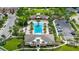 Aerial view of the community pool and clubhouse featuring clear blue water, palm trees and seating at 5240 Bentgrass Way, Bradenton, FL 34211