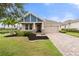 Charming single-Gathering home featuring a beautiful lawn, front porch, and two-car garage at 5240 Bentgrass Way, Bradenton, FL 34211