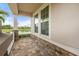 Relaxing front porch with stone accents and a view of the serene pond at 5240 Bentgrass Way, Bradenton, FL 34211