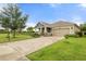 Charming single-story home with lush green lawn and brick-paved driveway at 5240 Bentgrass Way, Bradenton, FL 34211