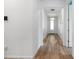 Inviting hallway with wood-look tile flooring and modern lighting at 5240 Bentgrass Way, Bradenton, FL 34211