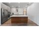 Stylish kitchen with stainless steel appliances, a center island, and modern lighting fixtures at 5240 Bentgrass Way, Bradenton, FL 34211
