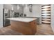 Modern kitchen featuring a center island, stainless steel appliances, and sleek cabinetry at 5240 Bentgrass Way, Bradenton, FL 34211
