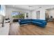 Inviting living room with a large blue sectional sofa, wood-look tile flooring, and a view of the backyard at 5240 Bentgrass Way, Bradenton, FL 34211